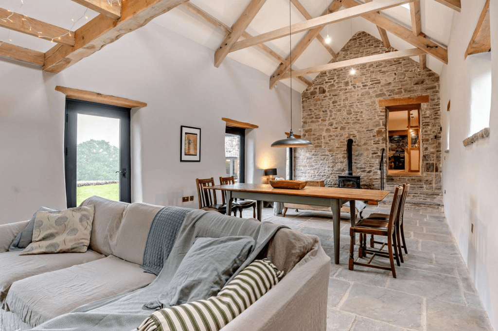Vaulted living room with exposed beams and dining area