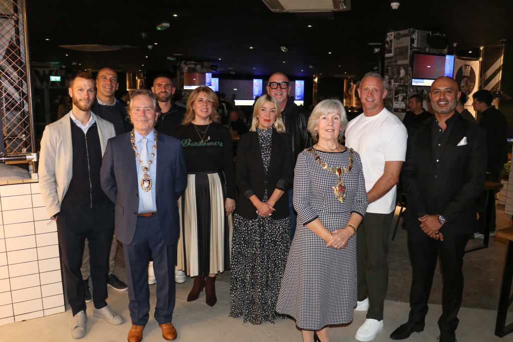 Group photo at The Swansea Jack opening featuring former Swansea City players, local dignitaries and venue owners.