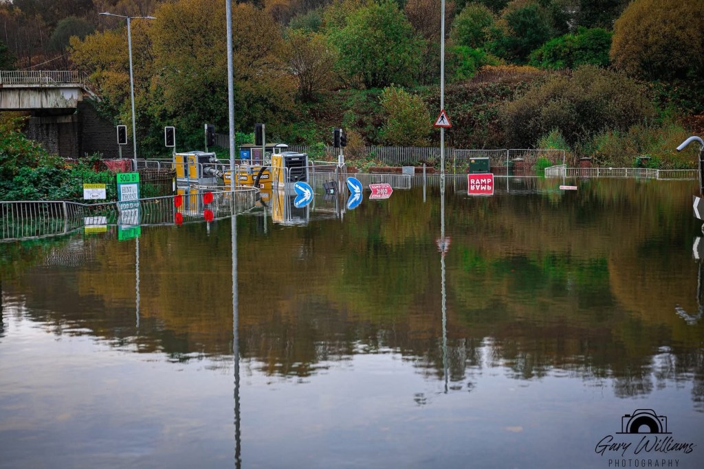 Floodwater surrounds pumping equipment on Cwmbwrla roundabout in Swansea during efforts to reduce water levels.