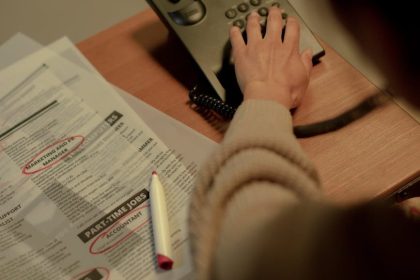 rear view on woman choosing number on phone