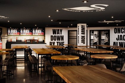 Interior view of The Swansea Jack sports bar showing bar, TV screens and Swansea City slogans on the wall.