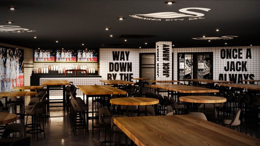 Interior view of The Swansea Jack sports bar showing bar, TV screens and Swansea City slogans on the wall.