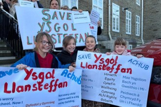 Protesters outside Carmarthen County Hall holding banners against Ysgol Llansteffan school closure