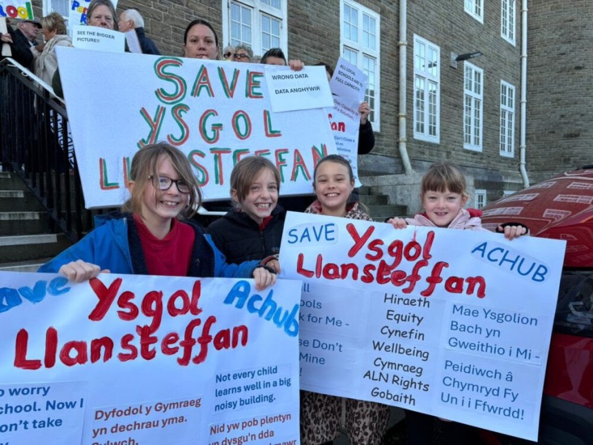 Protesters outside Carmarthen County Hall holding banners against Ysgol Llansteffan school closure