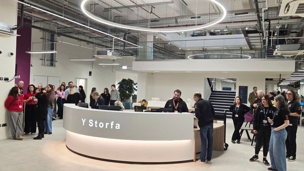 People gathered around the curved reception desk at Y Storfa, Swansea’s new public services hub.
