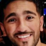 Close-up of PC Rehaan Akhtar smiling in a dimly lit venue. Credit: Family handout / South Wales Police