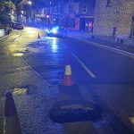 Sinkhole reopens on Brynymor Road, Swansea, with police lights and cones marking closure.