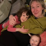 Naja smiling with her two children, family photo before illness worsened.