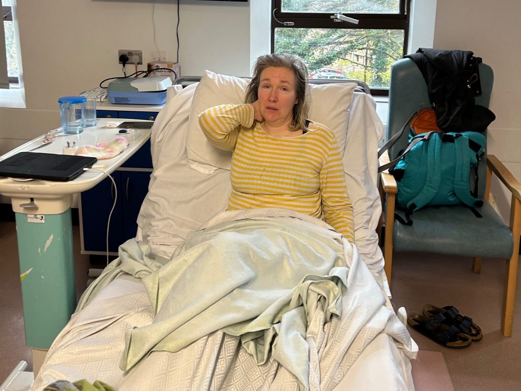 Naja lying in hospital bed, visibly unwell, fundraiser launched for treatment abroad.