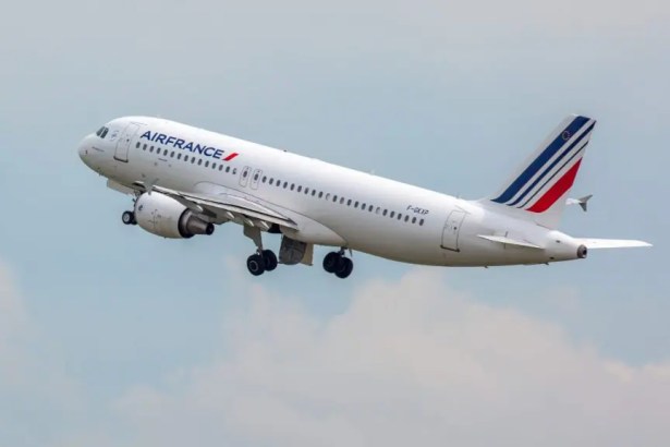 Air France Airbus narrow‑body jet ascending into the sky with landing gear deployed.