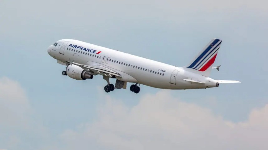 Air France Airbus narrow‑body jet ascending into the sky with landing gear deployed.