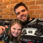 Teenager Hannah Poole smiling with her father in festive sweaters.