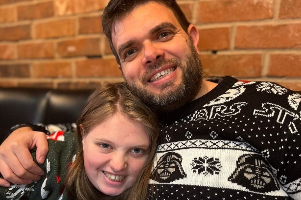 Teenager Hannah Poole smiling with her father in festive sweaters.