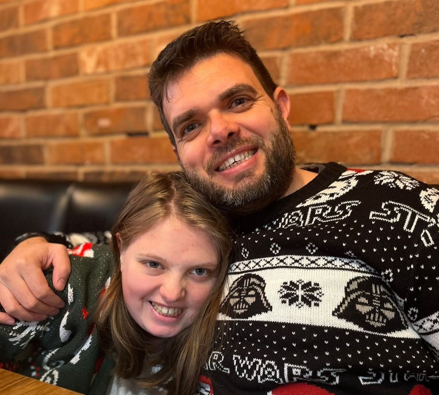 Teenager Hannah Poole smiling with her father in festive sweaters.