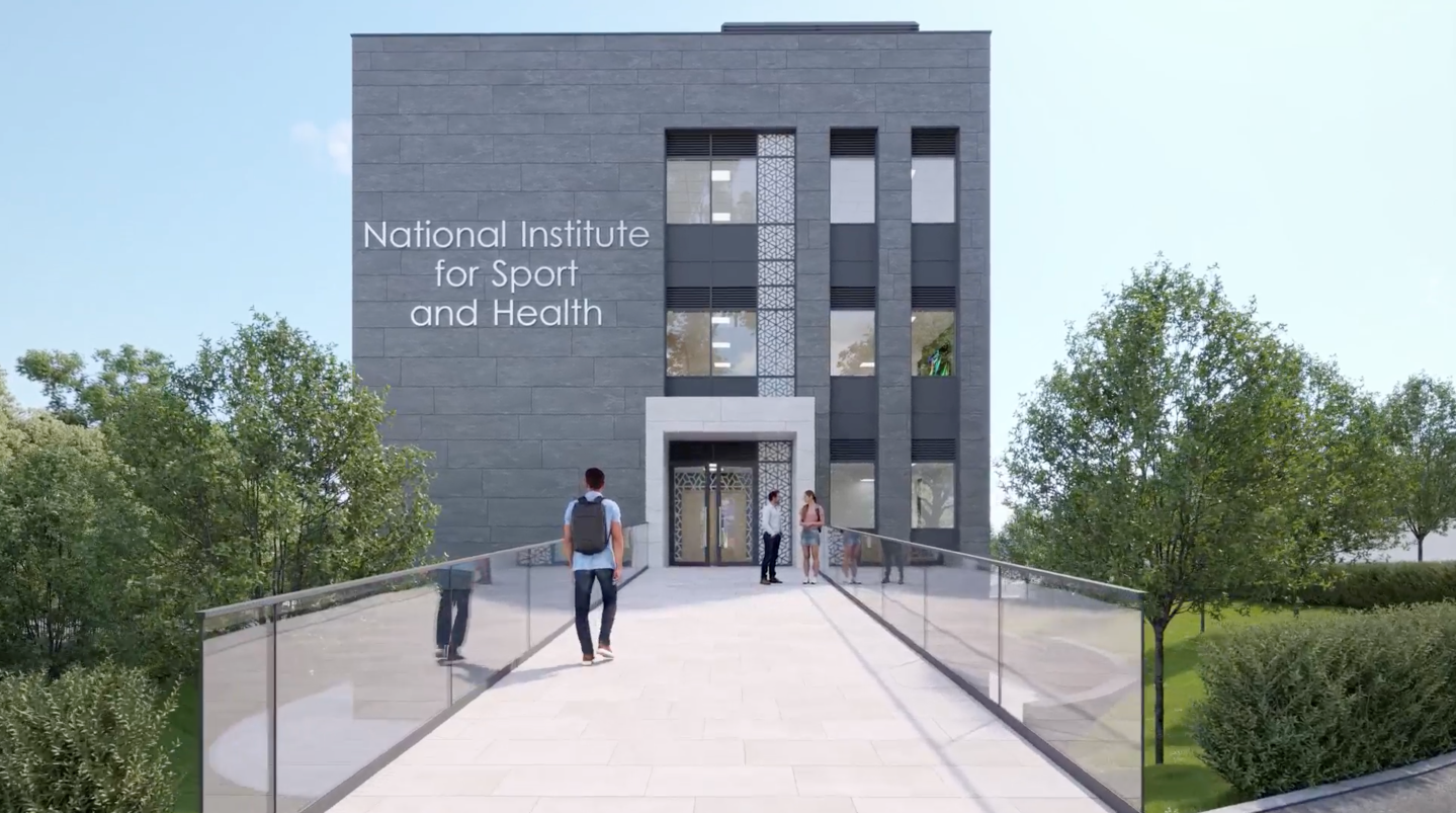 Modern building labeled National Institute for Sport and Health with landscaped entrance and glass walkway.