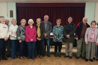Rev Emyr Gwyn with supporters at Gellimanwydd Chapel after completing his 100‑mile charity walk