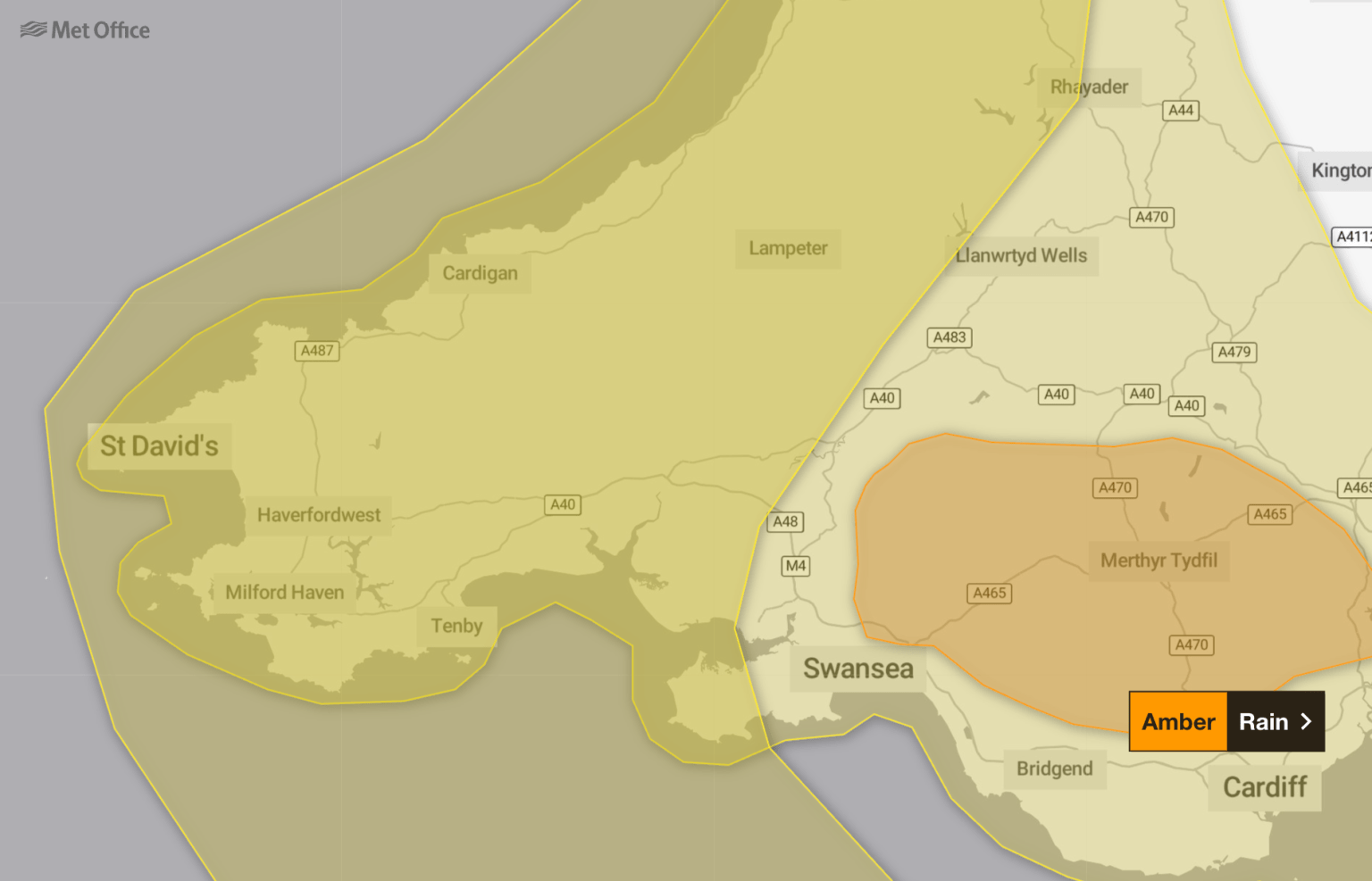 Met Office map highlighting yellow and amber rain warnings across South West Wales, with towns and roads labelled.