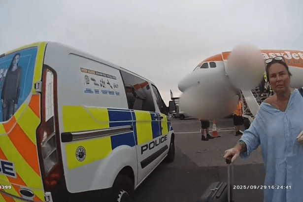 Police van and officers at airport as Lisa Regan is arrested near an EasyJet plane.