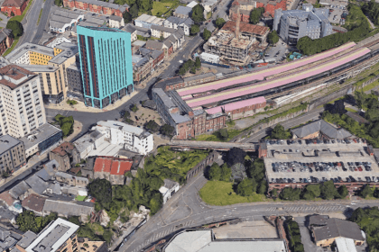 Aerial image of Swansea’s Strand area with railway station, car park, and student towers.