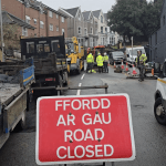 Road closed sign with highways crews at Brynymor Road sinkhole site.