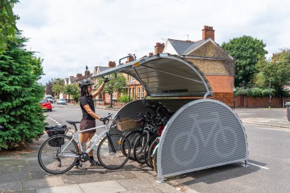Interior of cycle hangar showing metal racks and locking points for six bicycles.