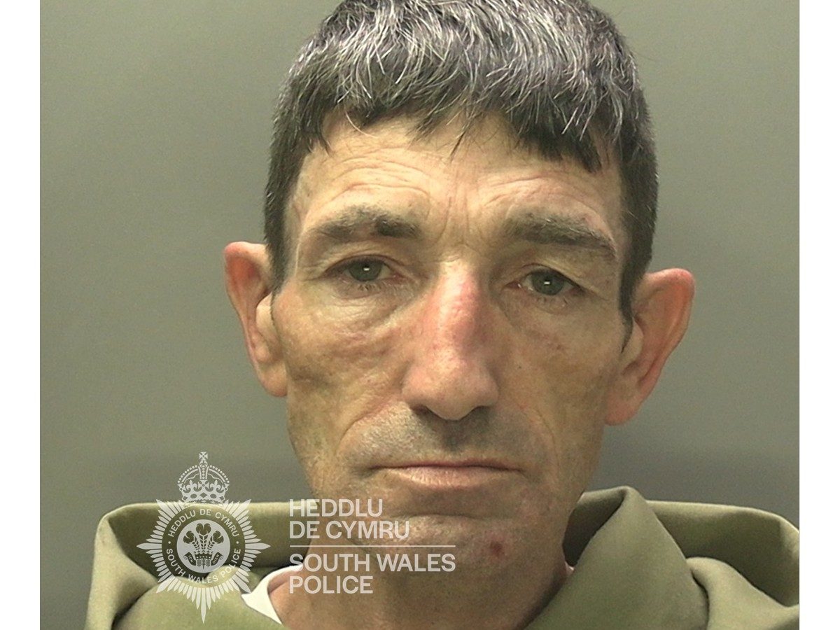 Police mugshot of Christopher Smith, 52, from Penlan, wearing a green hoodie.
