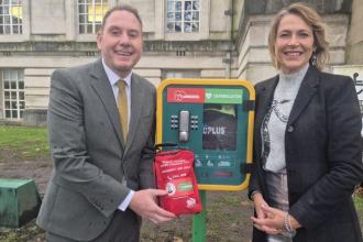 Rob Stewart and Melanie James standing beside a public bleed control kit in Swansea. Image credit: Swansea Council.