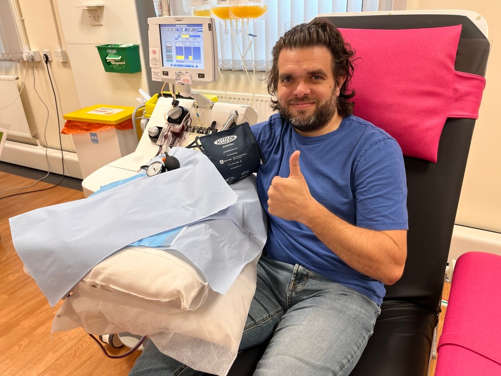 Platelet donor giving plasma during apheresis procedure.