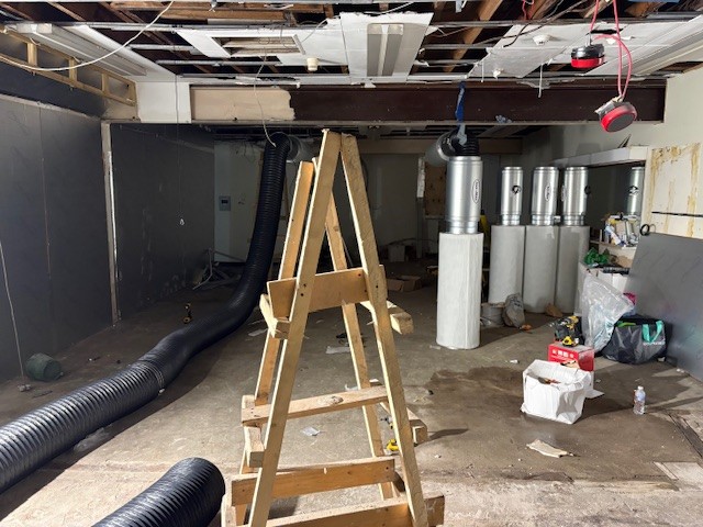 Construction site with black ducts and metal cylinders — suspected cannabis infrastructure inside former M&S.