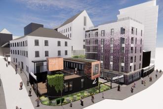 Digital rendering of Swansea’s Kings Lane regeneration showing modern buildings, rooftop greenery, outdoor seating, and pedestrian pathways behind the Urban Village.