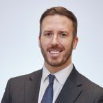 Professional headshot of Paul Kift, Principal of Gower College Swansea, wearing a dark suit and tie.