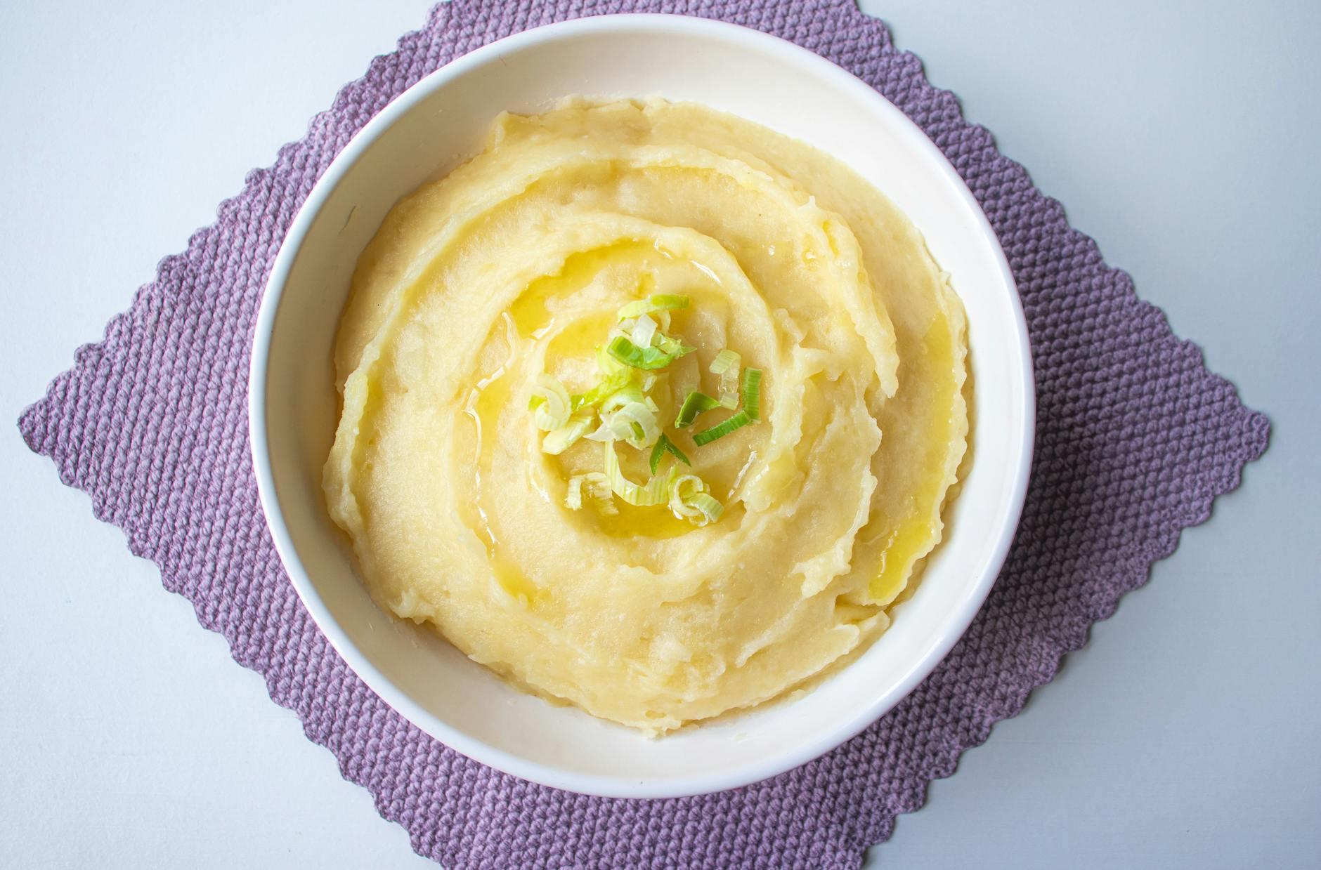 delicious creamy mashed potatoes in white bowl