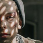 boy in gray and black camouflage jacket