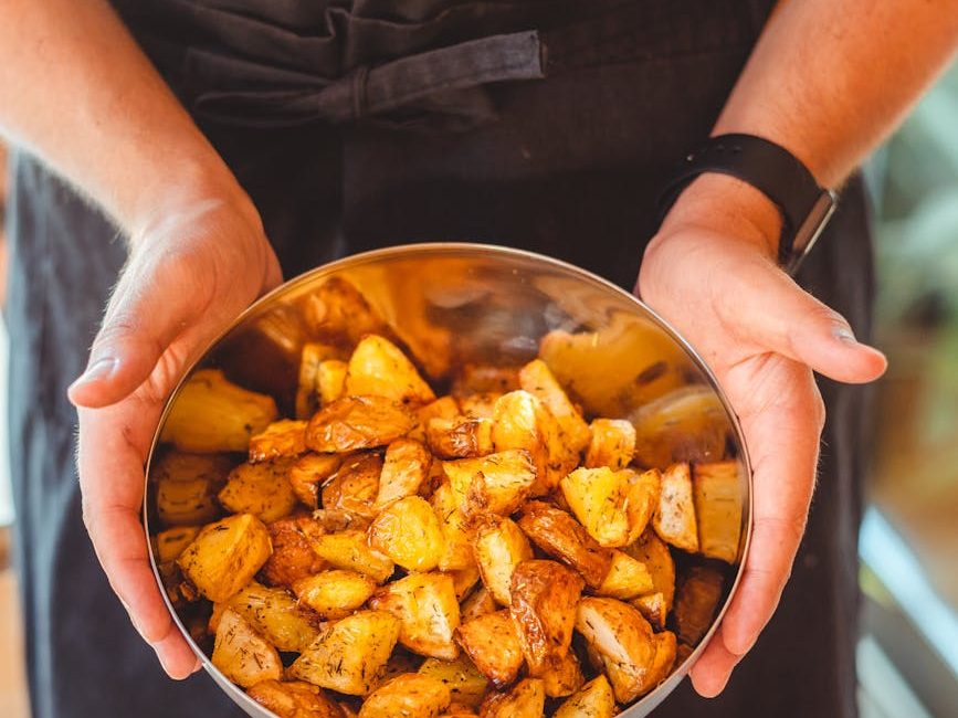 crop person with bowl of tasty potato