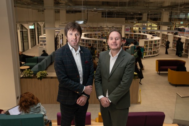 Steve Lemon and Rob Stewart stand inside Y Storfa with the new public library visible in the background.