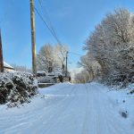 Snow‑filled rural lane in South Wales with deep snow covering the road and surrounding hedgerows. Image credited to 4x4 Response South Wales.