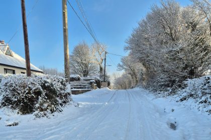 Snow‑filled rural lane in South Wales with deep snow covering the road and surrounding hedgerows. Image credited to 4x4 Response South Wales.