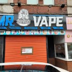 Red‑shuttered vape shop in Port Talbot with an official closure notice attached.