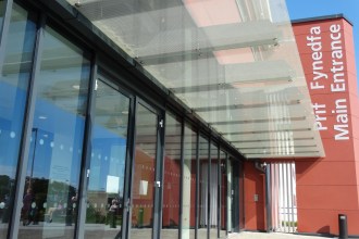 Entrance to Morriston Hospital during a period of high demand and infection‑related pressures.