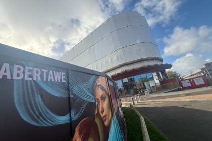 Copr Bay car park building with scaffolding taken down but exterior still covered in white protective plastic sheeting.