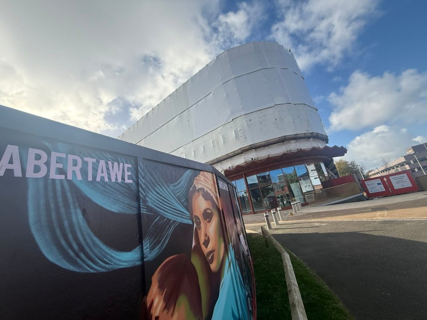 Copr Bay car park building with scaffolding taken down but exterior still covered in white protective plastic sheeting.