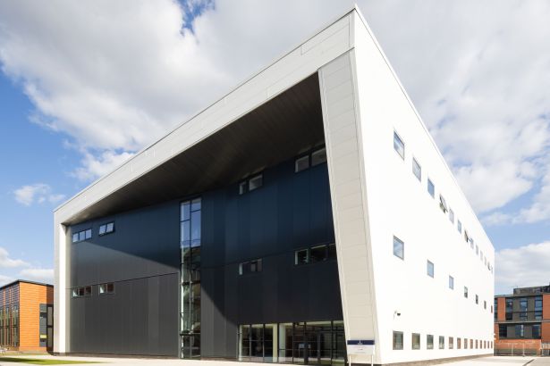 Exterior view of the rectangular CISM building at Swansea University’s Bay Campus, featuring black and white cladding.