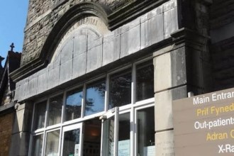 Close‑up view of the stone exterior of Maesteg Community Hospital, showing its historic architectural façade.