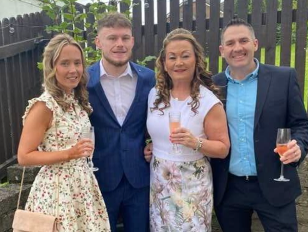 Cath John pictured with her family in a group photo after being awarded the King’s Ambulance Service Medal.