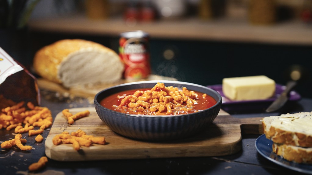 Tomato soup with flamin’ hot crisps scattered on top.