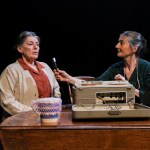 Lady Amy Parry‑Williams sits beside a recording device talking with a woman living in a Denbighshire workhouse while recording traditional Welsh folk songs.