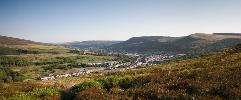 Scenic view of Maesteg town in the Llynfi Valley, surrounded by hills and countryside.