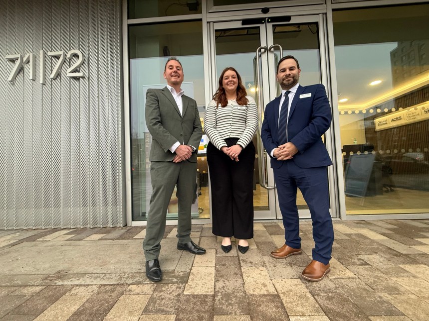 Cllr Rob Stewart standing with Briony Cotter and James Pearson at the 71/72 Kingsway office development in Swansea.
