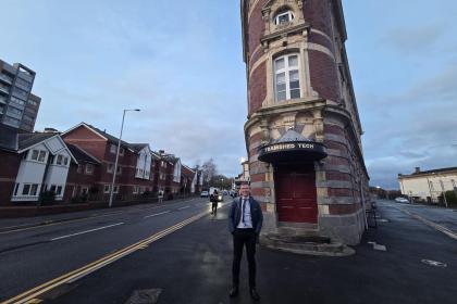Torsten Bell MP standing in front of the Palace Theatre in Swansea.