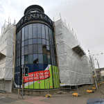 Street‑level view of the former Debenhams building in St Catherine’s Walk, Carmarthen, showing the large multi‑storey frontage.